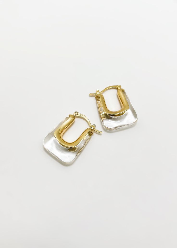 Our classic Christy earrings feature a rectangle shape and transparent gold finish. Perfect for everyday wear, these earrings are both stylish and sophisticated. - Hypoallergenic - 14K Gold Plated over Sterling Silver - Weight: 12 grams Shipping: Ready to Ship Silver Rectangular Everyday Earrings, Everyday Silver Rectangular Earrings, Classic Rectangular Earrings For Everyday, Gold Square Hypoallergenic Earrings, Trendy Rectangular Jewelry With Matching Earrings, Trendy Jewelry With Matching Rectangular Earrings, Trendy Silver Rectangular Earrings, Trendy Hypoallergenic Rectangular Jewelry, Modern Earrings With Rectangular Stone For Gift