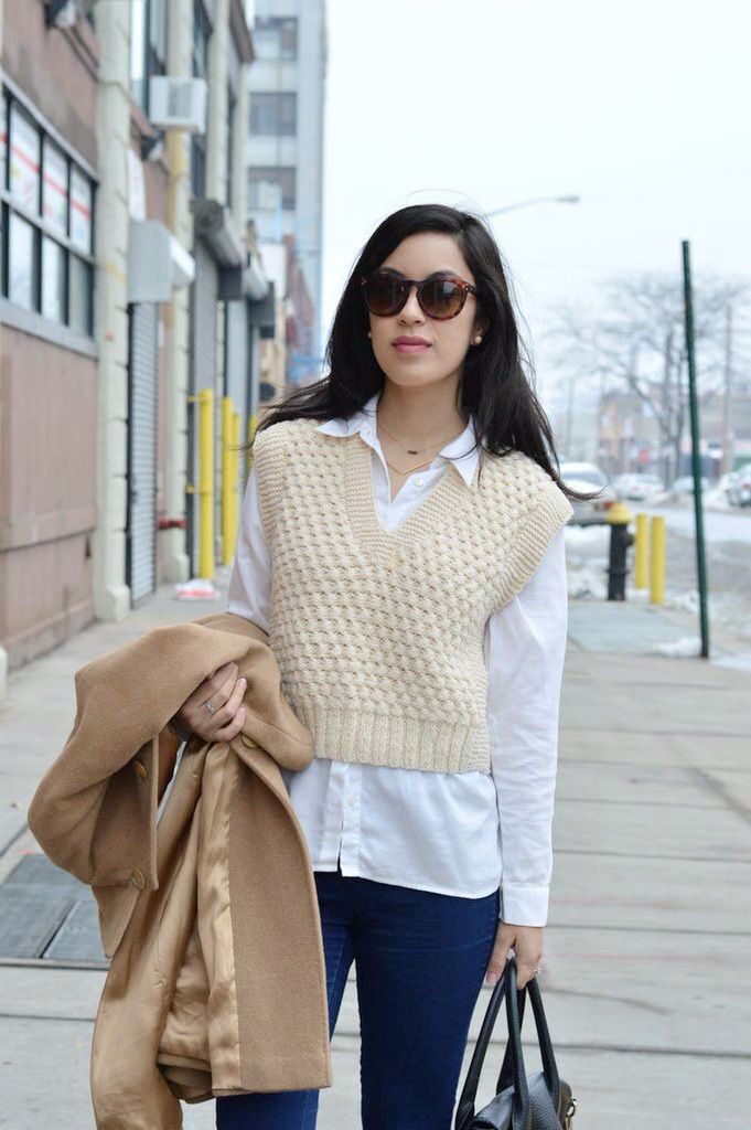 a woman is walking down the street with her purse