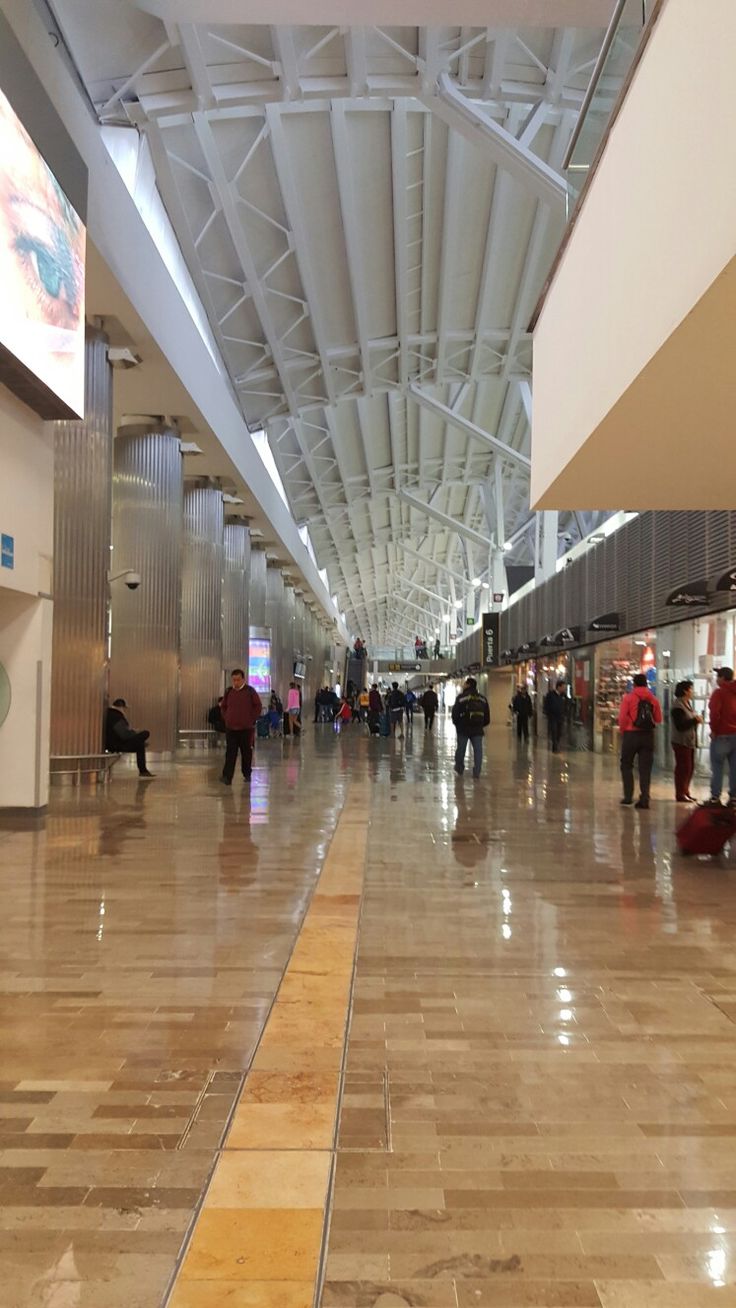 many people are walking through an airport terminal