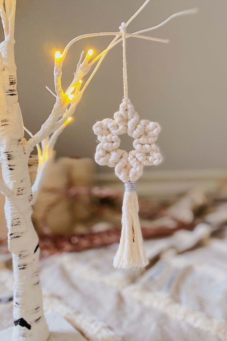 two ornaments hanging from a tree on a bed