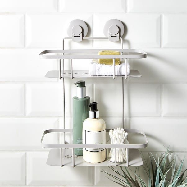 a bathroom shelf with soap, toothbrushes and other hygiene products hanging on the wall