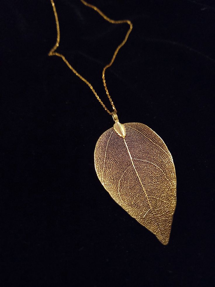 This beautiful necklace is made with a real leaf electroformed in gold. The amazing delicate details of the leaf has been preserved by an electroforming process creating a beautiful and unique gift of nature. This necklace is durable, lightweight and very elegant. These real leaves are from the evergreen Rudraksha tree.  Each leaf is unique, therefore, please expect a small variation from the leaves on the photographs. The leaves are around 2 inches (5cm) long, delicate looking but strong. The necklace is gold filled. What is gold filled: Gold Filled is the economical alternative to solid gold. The material consists of a brass core onto which a gold layer of gold is applied at high temperature. The gold content is at least 5% and the thickness of the gold layer is up to 100 times thicker t Yellow Gold Leaf Shape Nature-inspired Jewelry, Gold Leaf Nature-inspired Jewelry, Leaf-shaped Yellow Gold Brass Jewelry, Nature-inspired Gold Leaf-shaped Jewelry, Gold Leaf-shaped Nature-inspired Necklace, Nature-inspired Leaf Shaped Brass Jewelry, Nature-inspired Gold Leaf Necklace, Gold Leaf-shaped Brass Jewelry, Gold Leaf Shaped Brass Jewelry