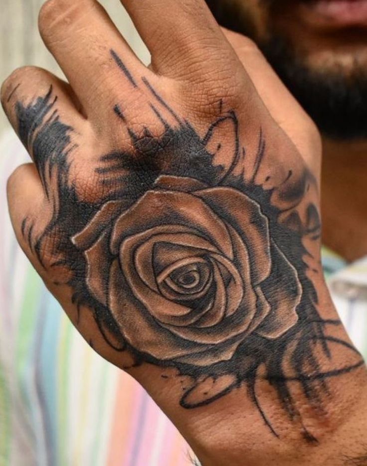 a man with a rose tattoo on his hand