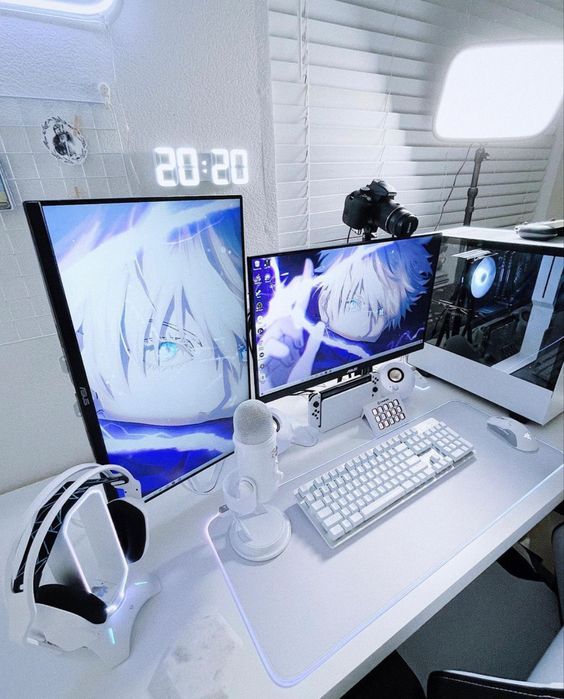 three computer monitors sitting on top of a white desk