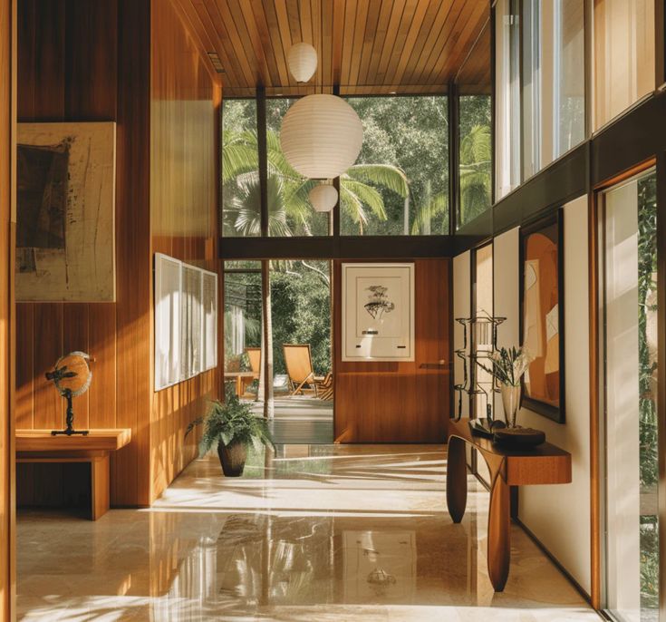 the inside of a house with wood paneling and glass doors leading to another room