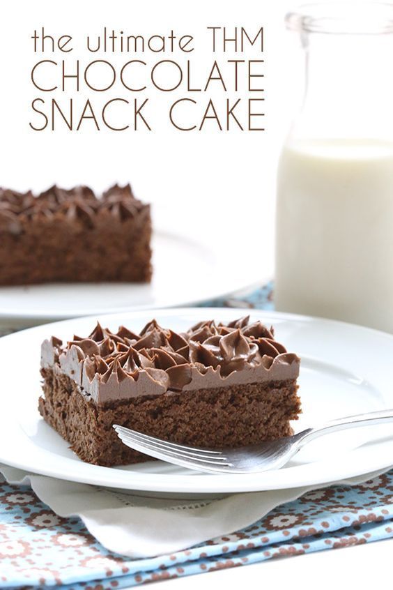 the ultimate thin chocolate snack cake on a white plate with a fork and glass of milk