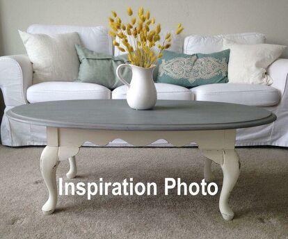 a living room with a couch, coffee table and pillows on the carpeted floor