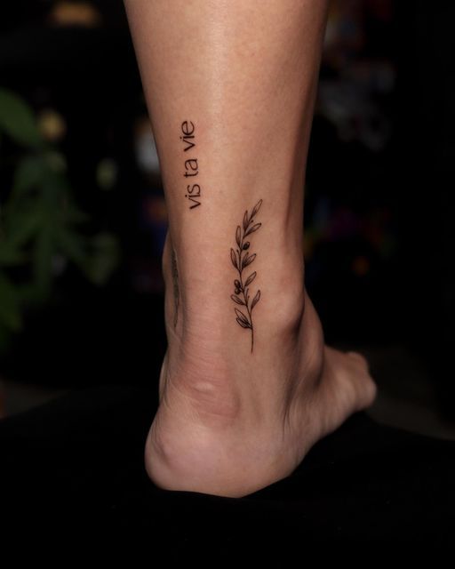 a woman's foot with a small tattoo on it