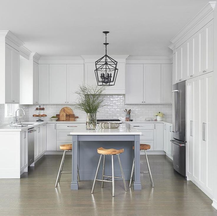 a kitchen with two stools at the center of the table and an island in the middle