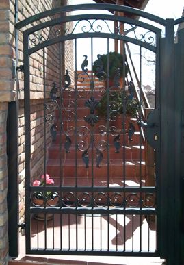 an iron gate is open to let people walk up and down the stairs