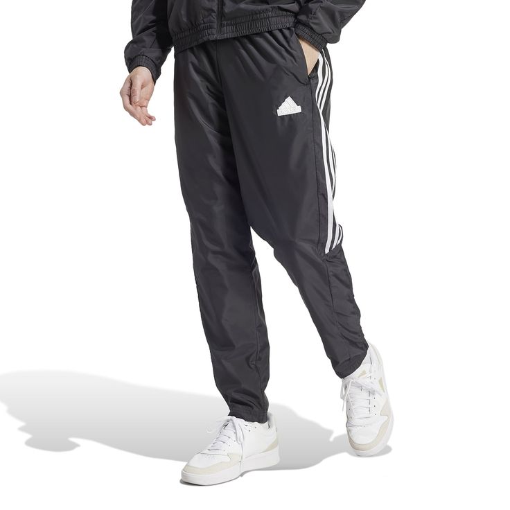 Influenced by the track but made for the streets, the adidas Tiro Woven Men's Pants have a classic style and a relaxed fit. You'll move, stretch, and bend, never feeling an ounce of restraint. Whether you want to keep your hands warm or a few of your essentials handy, you'll have pockets to do just that. Features adidas tri-stripe design. Elastic waistband. Two front pockets. Has logo on left thigh. Adidas Gym Pants With Three Stripes, Adidas Athleisure Jogging Pants, Adidas Logo Sweatpants For Training, Adidas Streetwear Pants With Elastic Side Panels, Adidas Sporty Relaxed Fit Joggers, Adidas Jogging Pants With Three Stripes, Adidas Athleisure Pants For Training, Adidas Training Pants With Three Stripes, Sporty Jogging Pants With Three Stripes