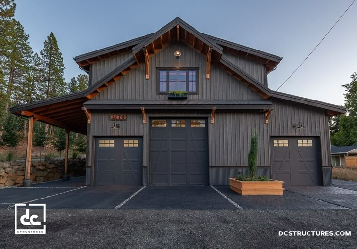 a large garage with two cars parked in front of it