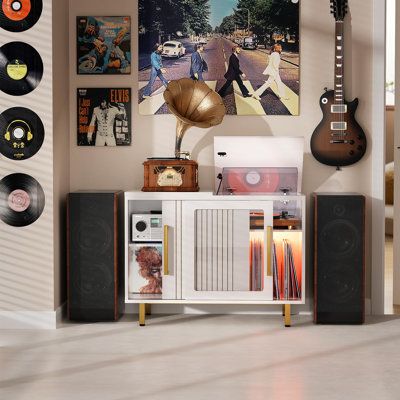 an entertainment center with record players, guitars and records on the wall in front of it