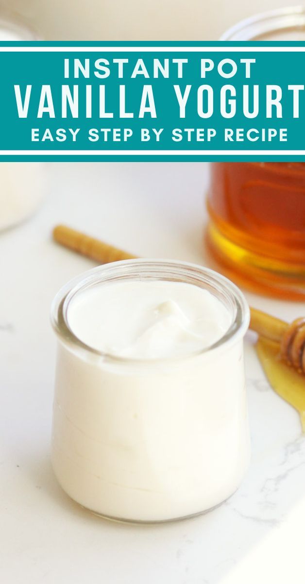 a jar of yogurt sitting on top of a counter next to a spoon