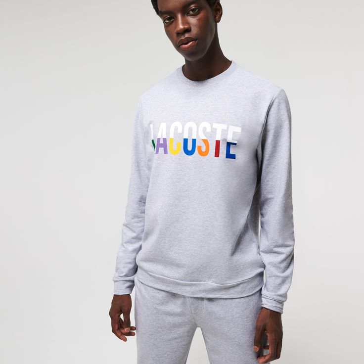 Adorned with oversized multicolor brand lettering, this solid lounge sweatshirt is perfect for kicking back. Crafted in soft cotton blend fleece, it has a classic straight cut and a ribbed crew neck. Get the total look when you pair it with the coordinating pants. Crew Neck Sweatshirt With Logo For Fall, College Crew Neck Sweatshirt With Logo Detail, College Sweatshirt With Logo For Fall, College Logo Detail Sweatshirt For Fall, College Logo Sweatshirt For Fall, Sporty Cotton Sweater With Logo Detail, Sporty Fall Sweater With Logo Detail, Casual College Sweatshirt With Logo Detail, Casual College Sweatshirt With Logo