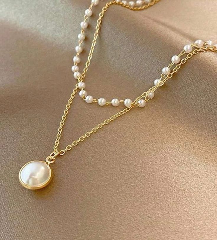 Radiate elegance with our Beautiful Gold Pearl Necklace. Crafted with exquisite detail, this timeless piece features lustrous pearls set in a delicate gold chain. Perfect for adding a touch of sophistication to any outfit. Elegant Gold Layered Necklace For Formal Occasions, Elegant Pearl Chain Necklace With Pearl Pendant, Pearl White Pearl Clavicle Chain Necklace, Chic Gold Pearl Chain Necklace, Elegant Layered Necklace With Adjustable Chain, Elegant Round Layered Necklace With Adjustable Chain, Gold Pearl Double Chain Necklace, Gold Double Strand Pearl Necklace With Adjustable Chain, Elegant Layered Pearl Necklace