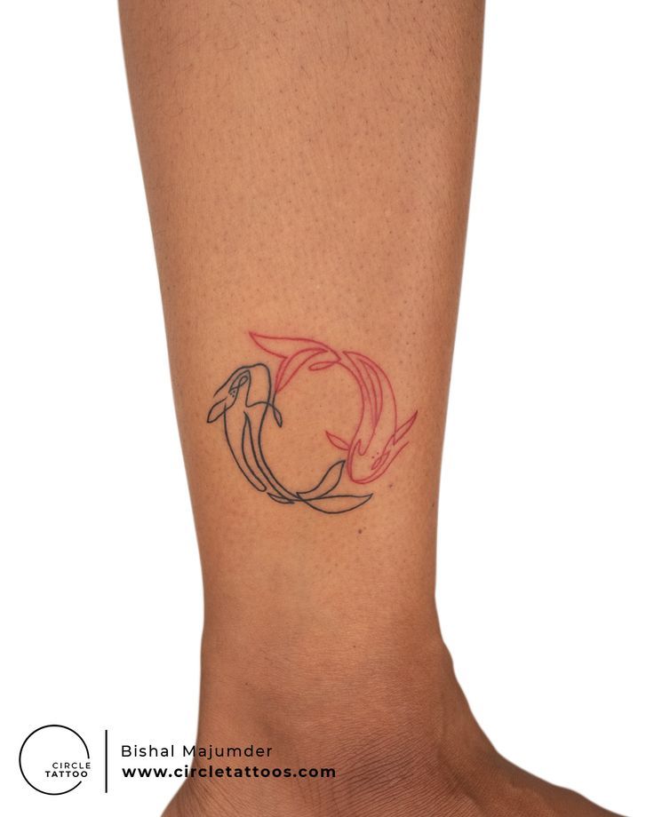 a woman's foot with a small tattoo on it