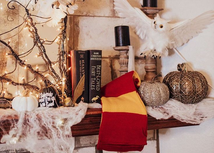 the mantle is decorated with books and decorations