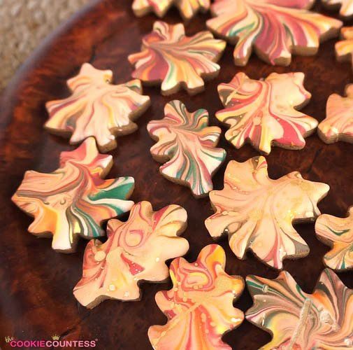 several decorated cookies sitting on top of a wooden table