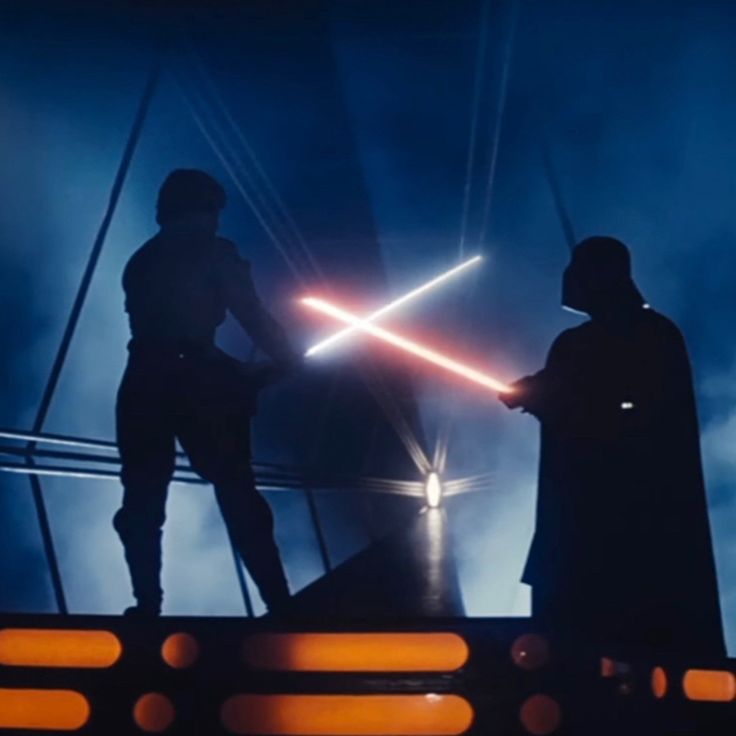 two people standing in front of a star wars scene