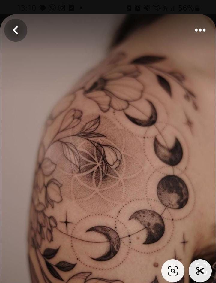 a man's shoulder with many phases of the moon and stars tattooed on it