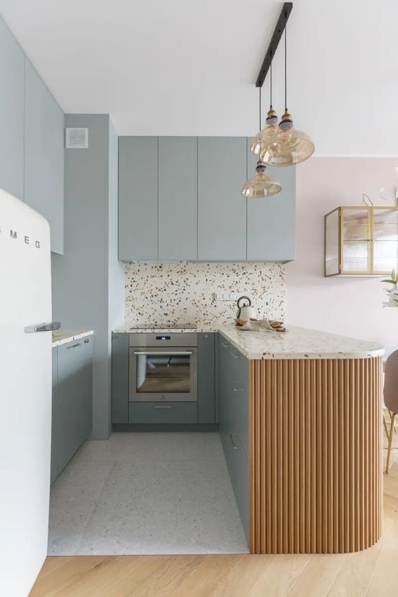 a kitchen with blue cabinets and white counter tops