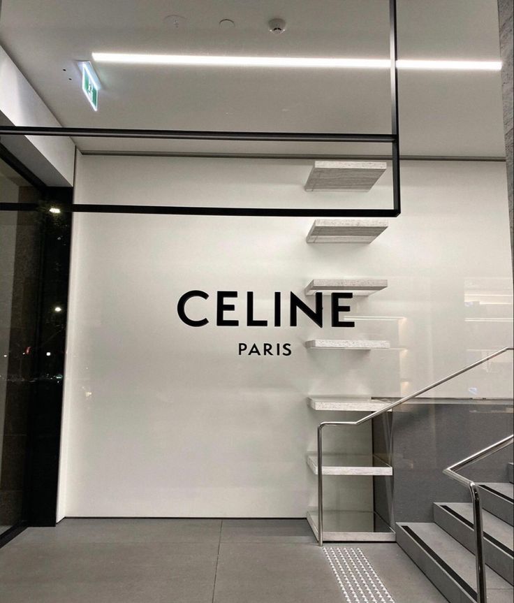 a store front with stairs leading up to the ceiling and below it is a sign that says, cline paris