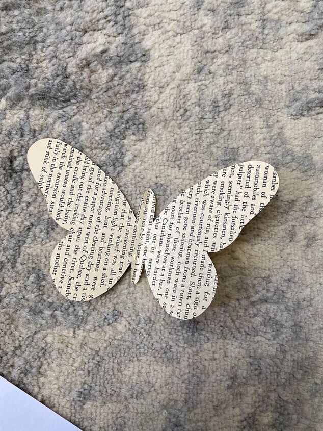 a cut out butterfly sitting on top of a piece of paper