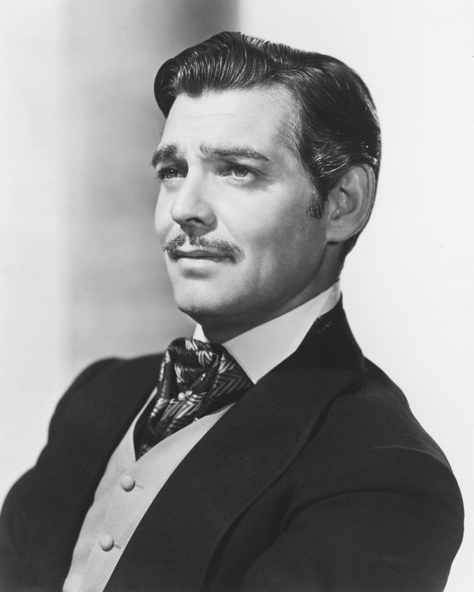 an old photo of a man in a suit with a moustache on his face