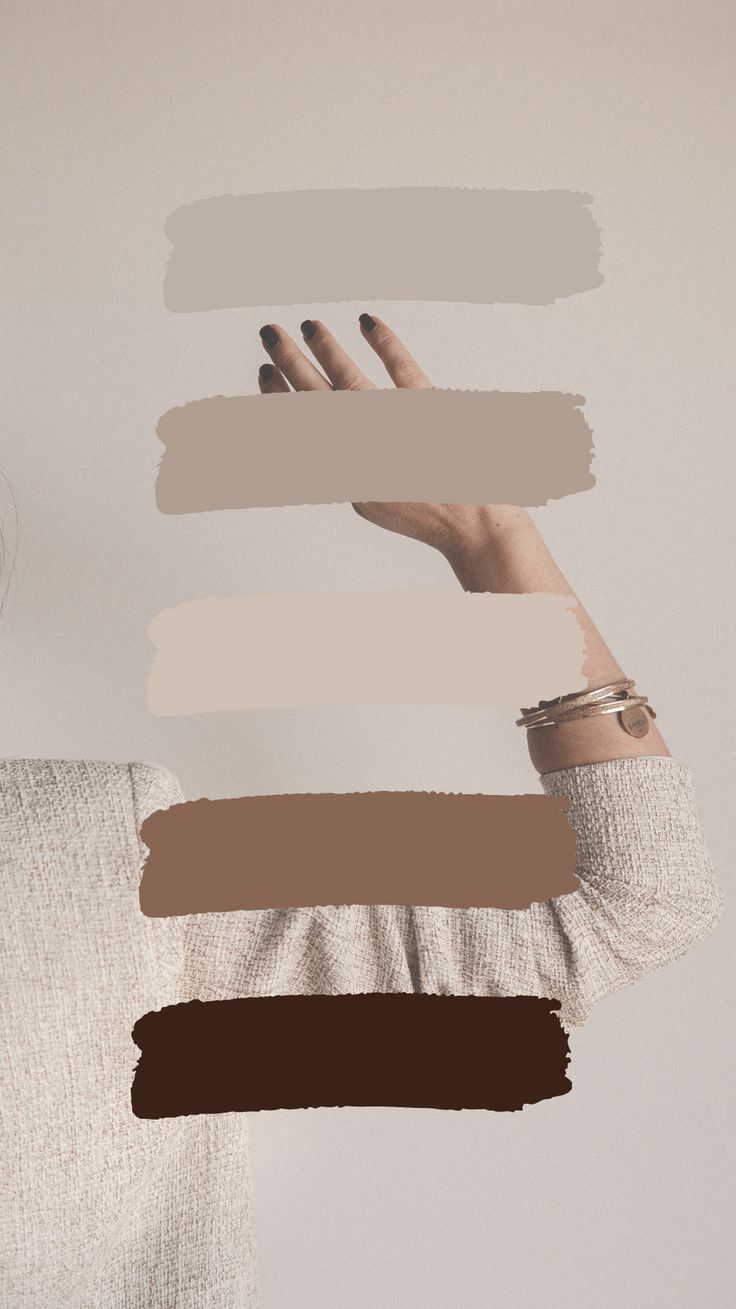 a woman holding her hands up in the air with different shades of paint on it