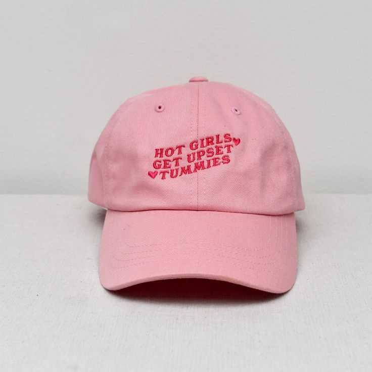 "Hot Girls Get Upset Tummies Embroidered Dad hat. This one's got a low profile with an adjustable strap and curved visor. * 100% chino cotton twill * Unstructured, 6-panel, low-profile * 6 embroidered eyelets * 3 ⅛\" (7.6 cm) crown * Adjustable strap with antique buckle" Pink Caps, Cap Store, Upset Tummy, Nurse Aesthetic, Pink Cap, Dad Hat, Cool Items, Shirts With Sayings, Trucker Cap