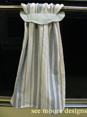 a white and blue striped curtain hanging on a wall next to a stove top with the words see more designs written below it