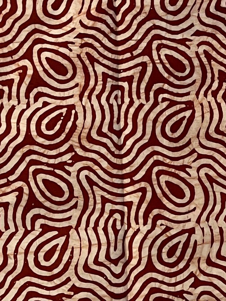 an image of a red and white pattern on wood grain paper that looks like wavy lines