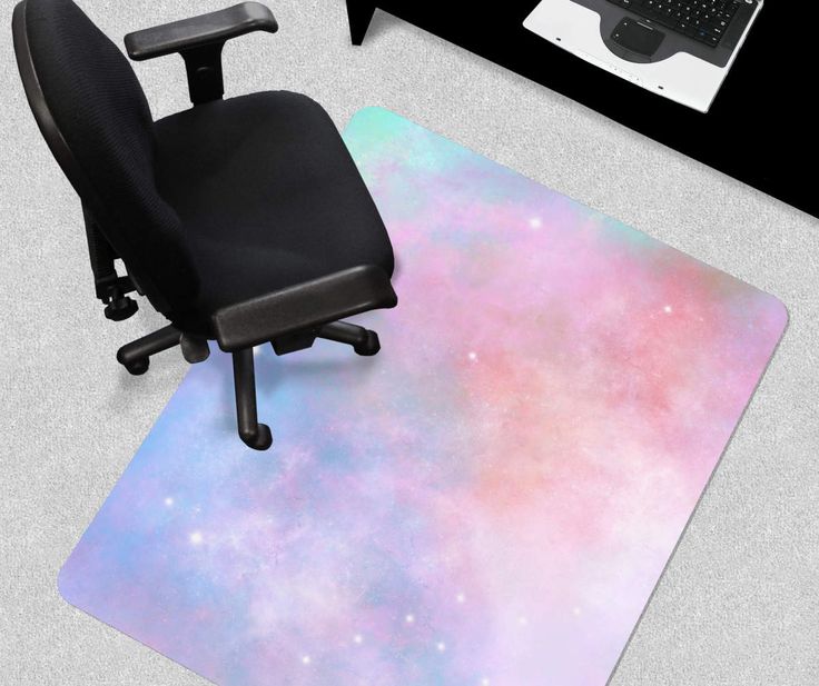 an office chair and desk with a computer on it in front of a space themed rug