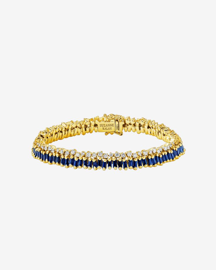 Discover a modern take on a timeless classic with this stunning short stack dark blue sapphire tennis bracelet from SUZANNE KALAN. The bracelet has been designed to add a touch of glamour and sophistication to any outfit, with 7.86 carats of vertically staggered baguette dark blue sapphires set on top of a row of unevenly set round white diamonds in a unique interpretation of our signature setting. Details 18k white gold, yellow gold or rose gold 7.68 carats of baguette dark blue sapphires 1.77 Luxury Blue Diamond Bracelet, Formal Sapphire Jewelry With Baguette Diamonds, Timeless Blue Jewelry With Baguette Diamonds, Luxury Blue Baguette Diamond Jewelry, Luxury Gold Sapphire Tennis Bracelet, Classic Sapphire Jewelry With Baguette Diamonds, Elegant Sapphire Jewelry With Baguette Diamonds, Luxury Sapphire Jewelry With Baguette Diamonds, Sapphire Tennis Bracelet