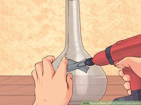 a person using a drill to fix a glass bottle