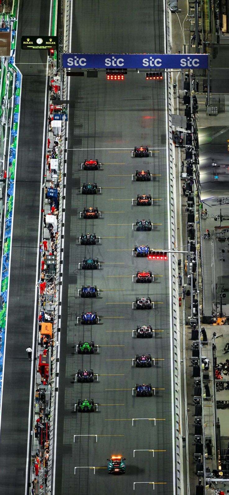 an aerial view of a race track with cars on it and the starting line lined up