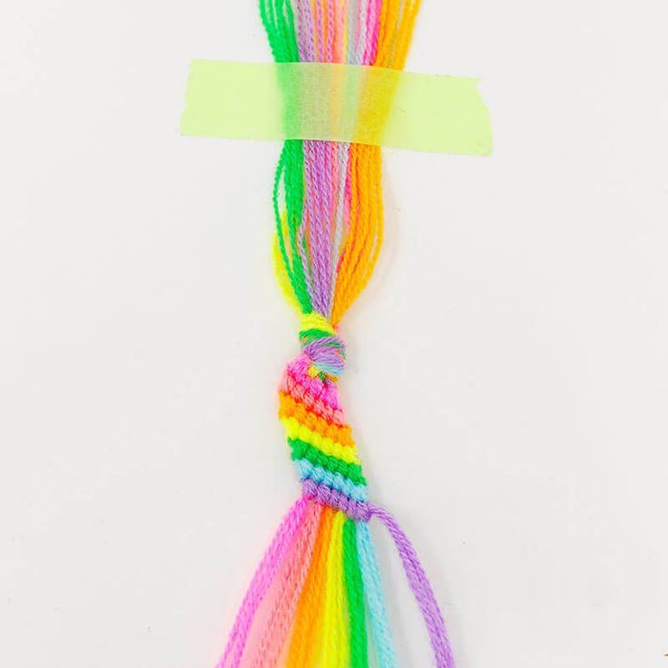 multicolored loom bracelets on white background with adhesive tape in the middle