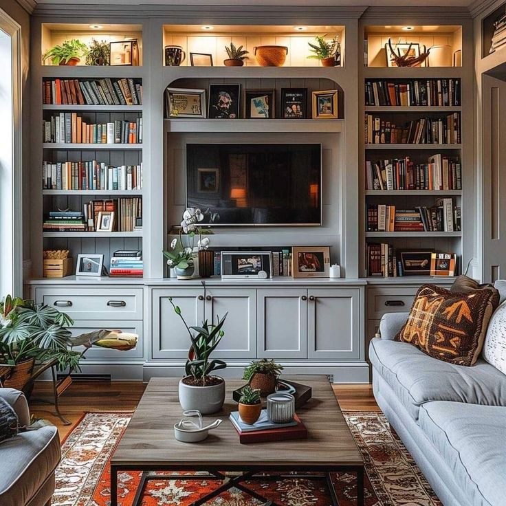 a living room filled with lots of furniture and bookshelves above a tv mounted on a wall