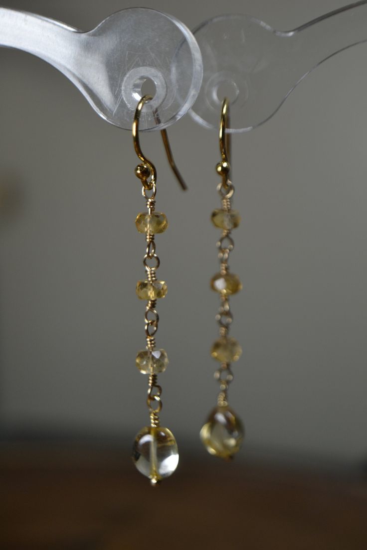 "These Citrine Earrings displays stunning, natural golden yellow gemstones. A very dainty, delicate style that is suitable for everyday attire or evening wear. Match it with our Citrine Nugget bracelet for a complete look! Citrine is a stone of prosperity and happiness and belongs to the Sacral Chakra. Citrine represents the Birthstone for the month of November and also represents the 13th Anniversary Precious Stone Gift. >Citrine, November Birthstone Earrings, Dainty Citrine Earrings, Long C Adjustable Citrine Yellow Gold Jewelry, Adjustable Yellow Gold Citrine Jewelry, Yellow Gold Gemstone Dangle Earrings, Gold Briolette Earrings, Pierced, Gold Briolette Fine Jewelry Earrings, 14k Gold Briolette Pierced Jewelry, Pierced Briolette 14k Gold Jewelry, Elegant Hypoallergenic Yellow Earrings, Gold Briolette Earrings