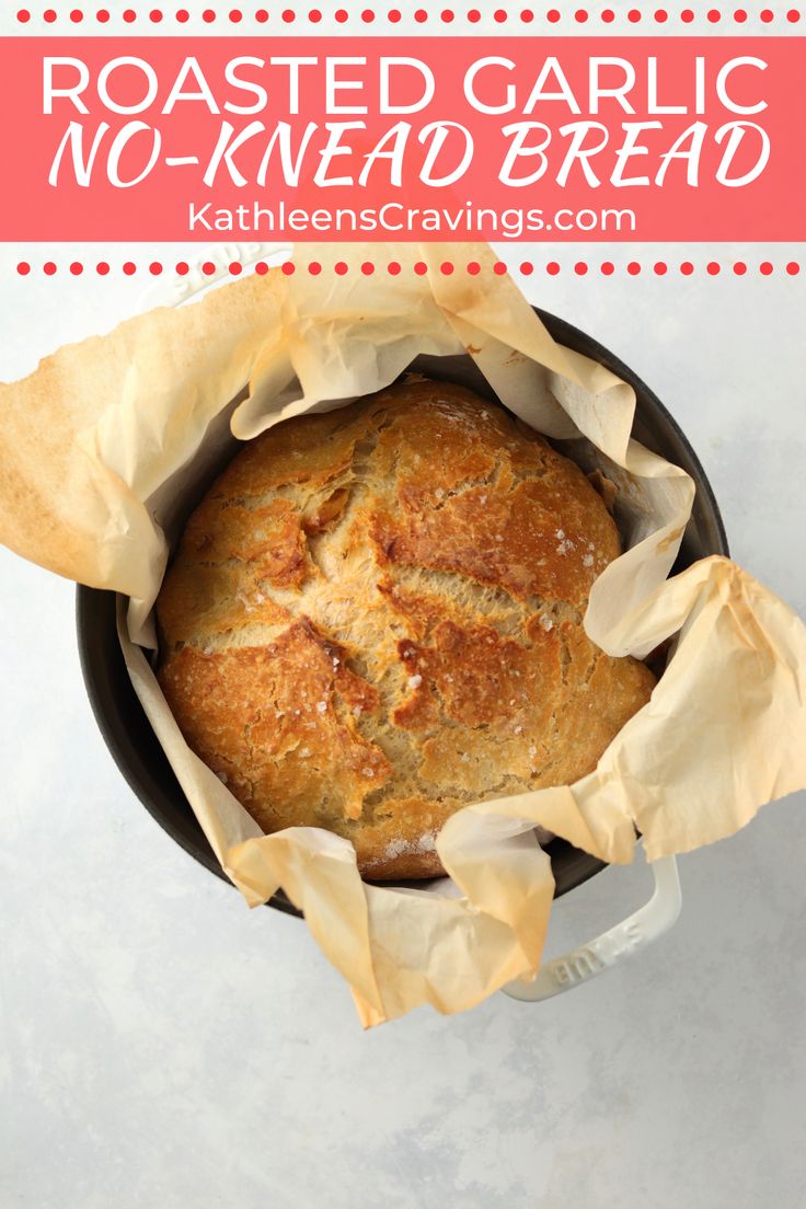 a loaf of bread sitting in a pan with the words roasted garlic no - knead bread