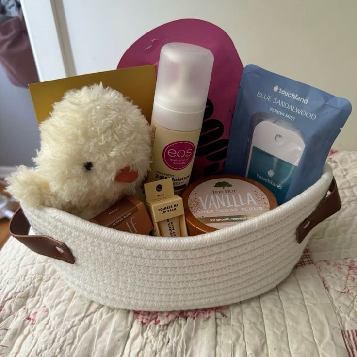 a teddy bear is sitting in a basket filled with beauty products and personal care items