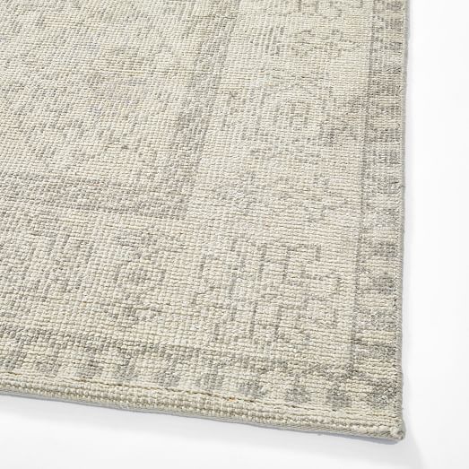 a white rug with an intricate design on the top and bottom part of it's surface