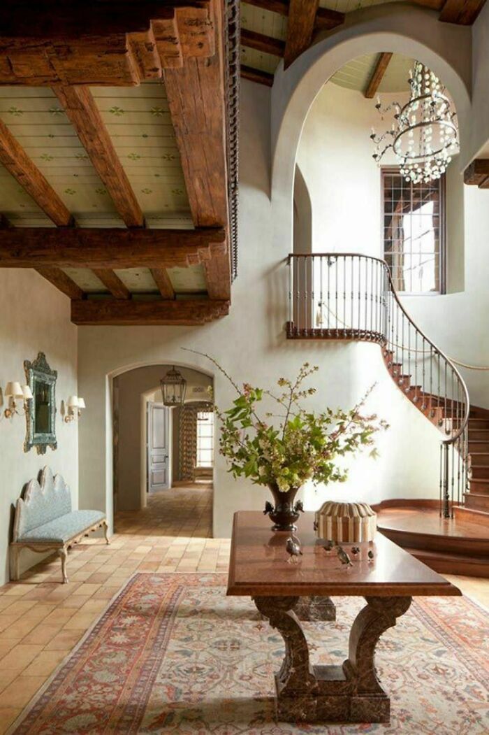 a living room filled with furniture and a staircase