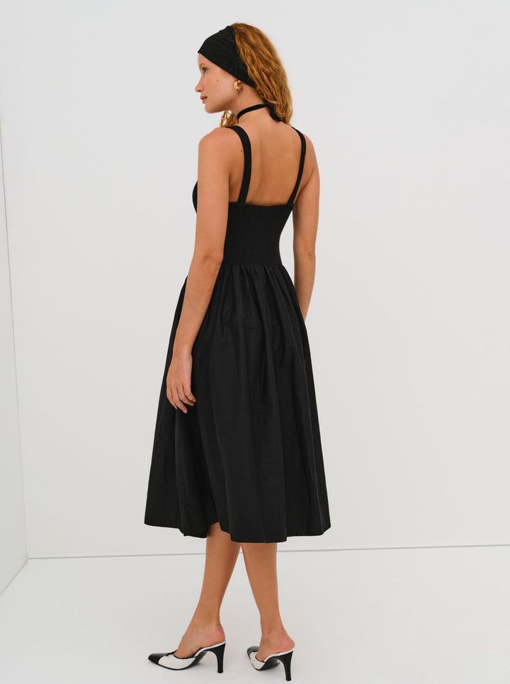 The Billie Midi dress by For Love & Lemons is a timelessly elegant dress that will remain in your wardrobe for years to come! This midi dress has a poplin skirt, a knit bodice, and a poplin rosette. Available in both cream and black. Cocktail Dress With Gathered Voluminous Skirt, Cocktail Dress With Voluminous Gathered Skirt, Elegant A-line Midi Dress With Smocked Back, Evening Dresses With Smocked Back And Midi Length, Ruched Dress With Fitted Bodice And Full Skirt, Evening Midi Dress With Smocked Bodice, Pleated Full Skirt Dresses For Daywear, Elegant Fit And Flare Dress With Smocked Bodice, Voluminous Full Skirt Dress With Pleated Waist