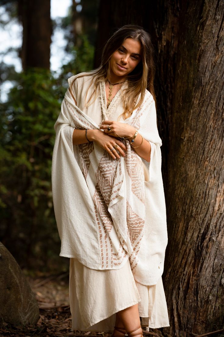 The Free Mind Kimono is designed to be light and breezy. Featuring a unique, tribal block print and made with natural colours and fibres. This kimono is a beautiful addition to a bohemian wardrobe, perfect to drape over an outfit to add a touch of alternative style. Material : 100% Cotton Hand made with Love ❀ Flowy Bohemian Poncho For Beach Cover-up, Beige Flowy Bohemian Kimono, Flowy Bohemian Beige Kimono, Bohemian Block Print Kimono For Vacation, Bohemian Block Print Kimono For Summer, Bohemian Block Print Summer Kimono, Beige Bohemian Long Kimono, Beige Long Bohemian Kimono, Bohemian Beige Kaftan For Spring