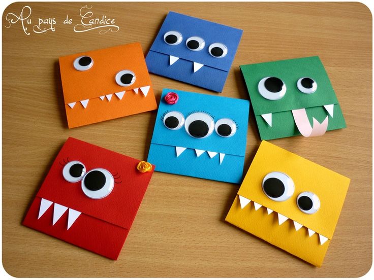 four different colored paper monsters on a table