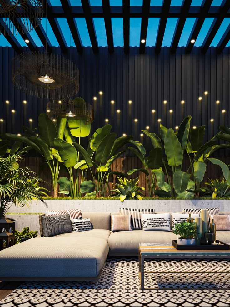 a living room filled with lots of furniture next to a plant covered wall and ceiling