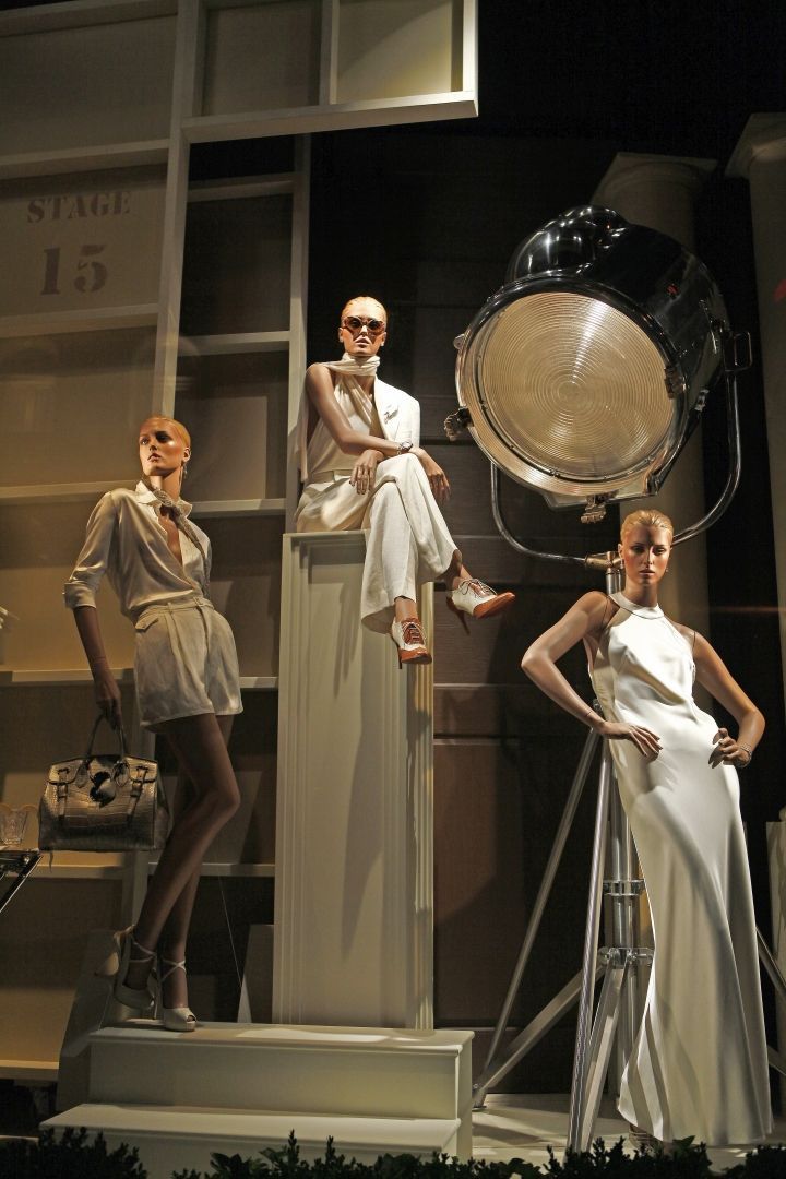 three mannequins are posed in front of a camera and some lighting equipment