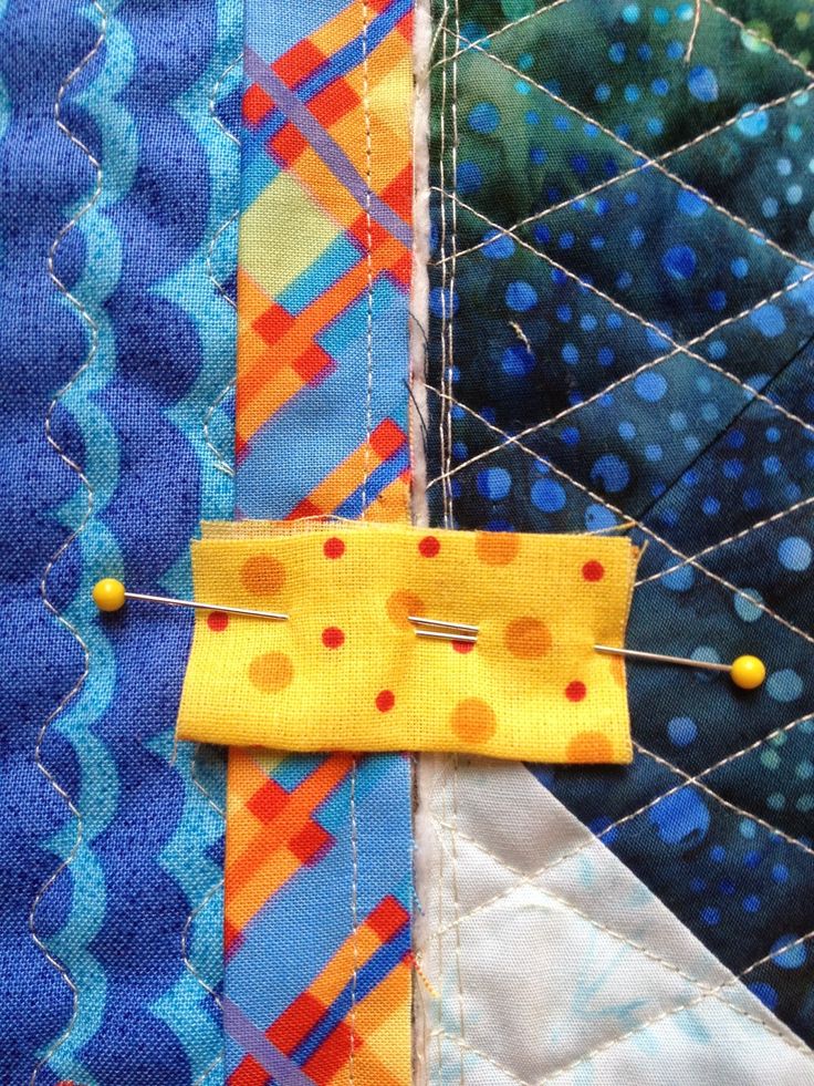 a piece of fabric is stitched together with pins